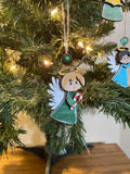 Decorative Angel ornaments on a Christmas tree with lights